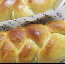 Black gallon of light cream braided bread