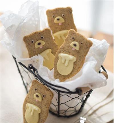 A cute cookie with a little bit of honey - a bear stealing honey